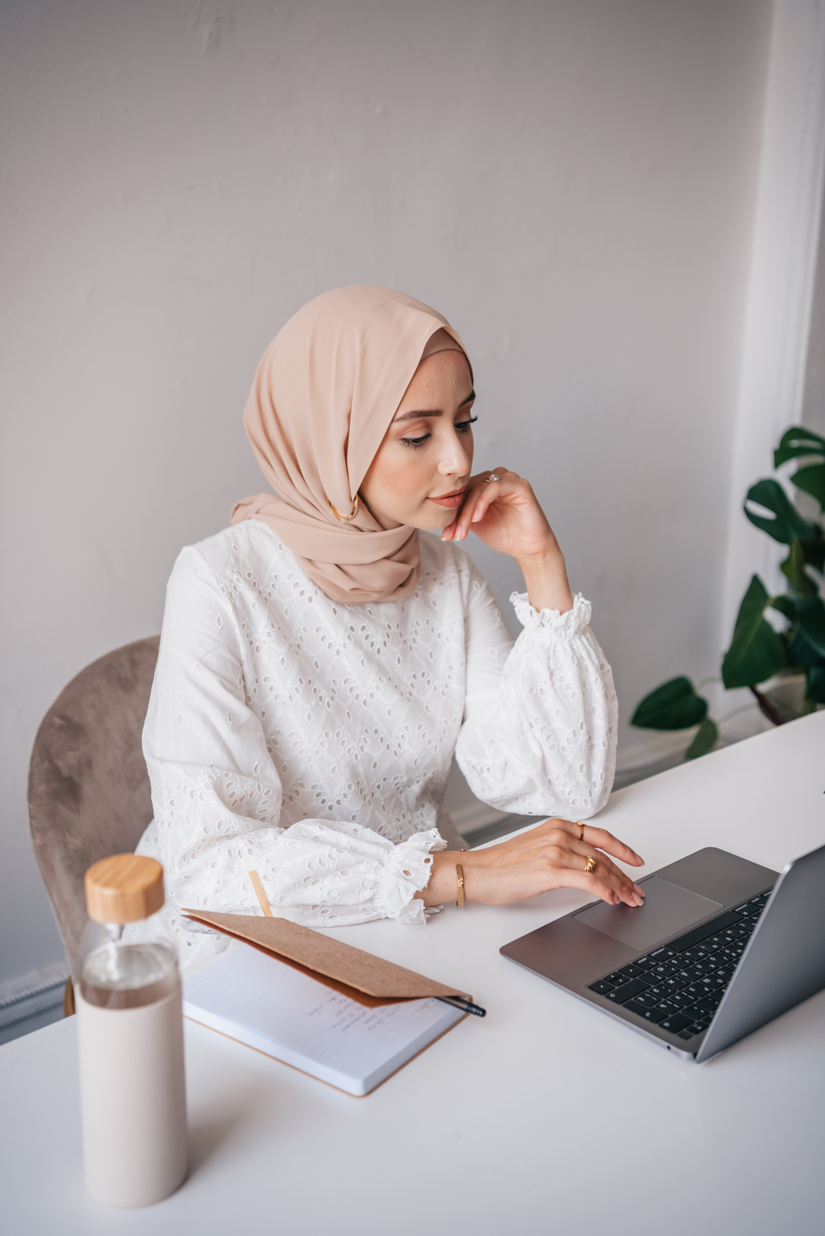 Woman in White Hijab Using Macbook Air