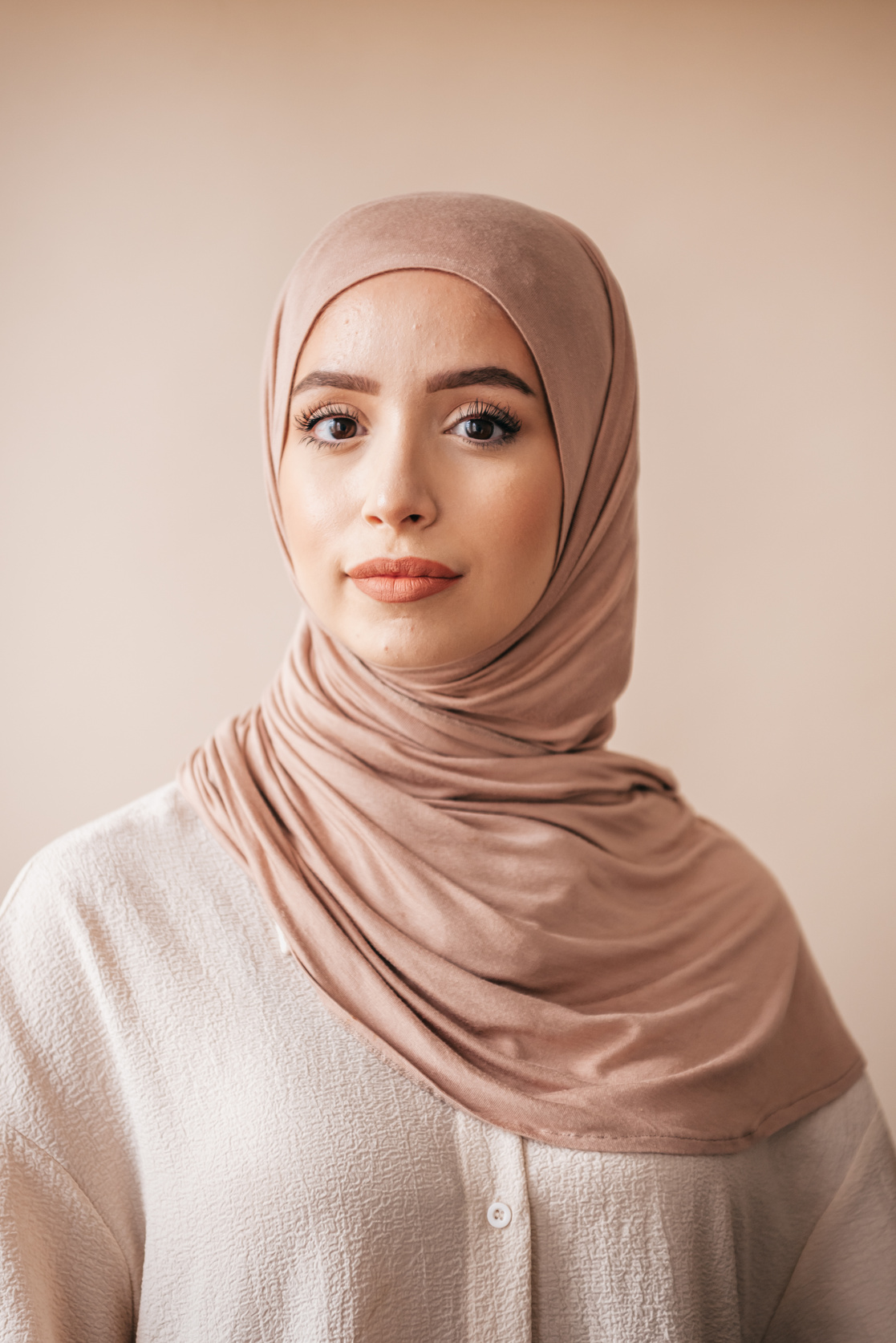A Woman in Brown Hijab and White Long Sleeve Shirt